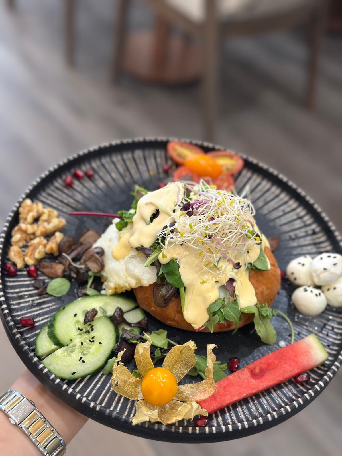 Elegant breakfast plate with eggs benedict and fresh garnishes